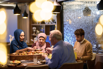 Fototapeta na wymiar A modern and traditional European Islamic family comes together for iftar in a contemporary restaurant during the Ramadan fasting period, embodying cultural harmony and familial unity amidst a