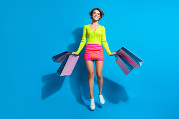 Full length body photo banner of overjoyed young lady dressed glamour apparel with pile gift bags...