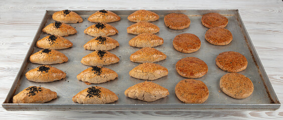 Pastries made from buckwheat flour on a baking tray. Sesame pastries made from chickpea, sorghum...