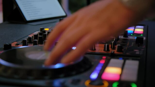 Close up shot of DJ Sound mixer at night event, 