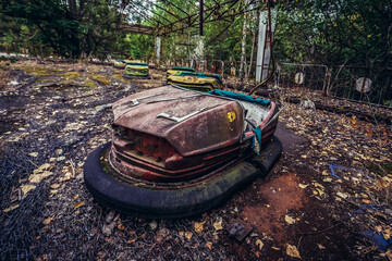 Red bumper car in Pripyat abandoned city in Chernobyl Exclusion Zone, Ukraine