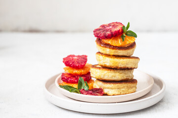 Stack of pancakes with blood orange and honey 