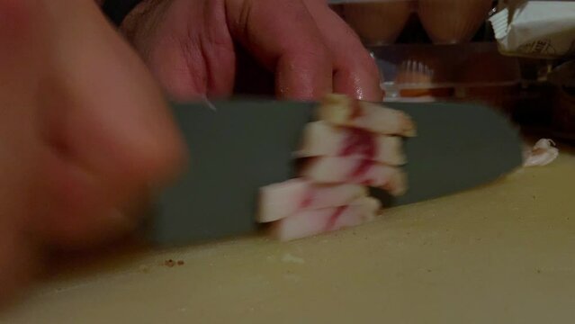 preparation of carbonara pasta, cutting of sliced pork cheek