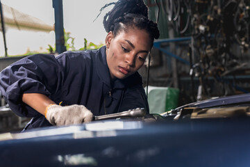 Black auto mechanic woman fixing car and maintenance  in auto repair  shop