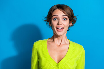Photo of astonished pretty lady open mouth cant believe empty space isolated on blue color background - obrazy, fototapety, plakaty