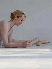 Ballerina doing splits and reading a book. Balancing Dance Passion and school Education, Strength in Body and Mind Concept