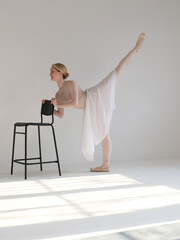 Ballerina doing leg extension , Arabesque position training, Ballet legs workout. Grace and Strength of Femininity concept