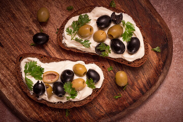 Breakfast, sandwiches, with cream cheese, olives, top view,