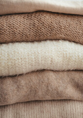 woolen clothes of light shades, folded on a white background mockup