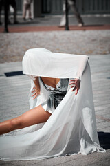 Young sexy girl in space silver micro skirt dancing with white silk scarf waving gracefully, female...