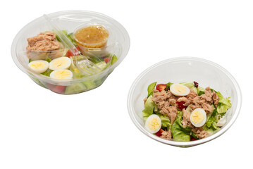 Fresh tuna salad with lettuce, cucombers, cherries and eggs in plastic container.