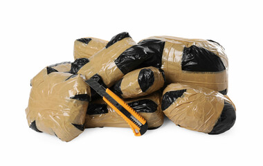 Packages with narcotics and stationery knife isolated on white