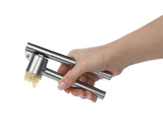 Woman squeezing garlic with press on white background, closeup