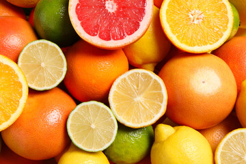 Different fresh citrus fruits as background, top view