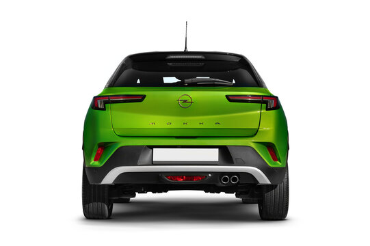 Studio shot of the rear view of a green 2022 Opel Mokka model against a transparent background