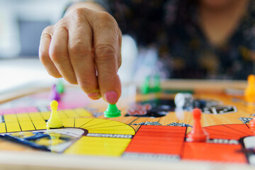 a woman playing ludo on a board game