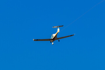 Ultralight plane with prolonge fyling on blue sky. Aviation background