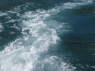 Seafoam trail across water