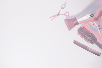 Hairdresser tools with copy space on the white background. Hairstyling accessories in silvery pink metallic color scheme.