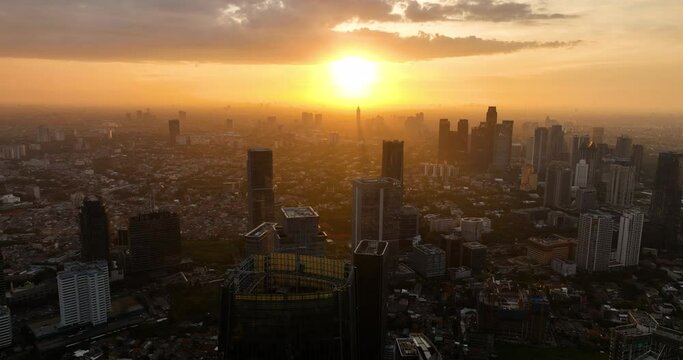 Jakarta with modern buildings at sunset view from above. Urban landscape. Indonesia.
