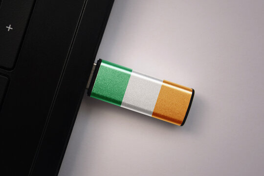 usb flash drive in notebook computer with the national flag of ireland on gray background. - Powered by Adobe