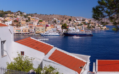Multi-colored facades of houses in the Greek village Symi on a sunny day - 755858570