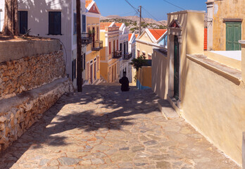 Old narrow traditional street in the Greek village of Symi. - 755859194