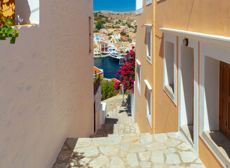 Old narrow traditional street in the Greek village of Symi. - 755859331
