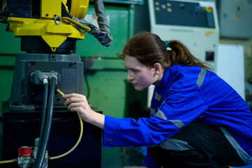 Female Robotics engineer working with Programming and Manipulating Robot Hand, Industrial Robotics Design