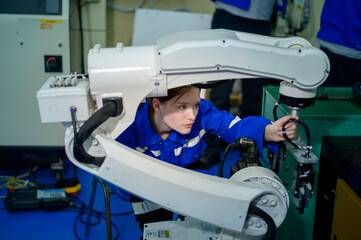 Female Robotics engineer working with Programming and Manipulating Robot Hand, Industrial Robotics Design