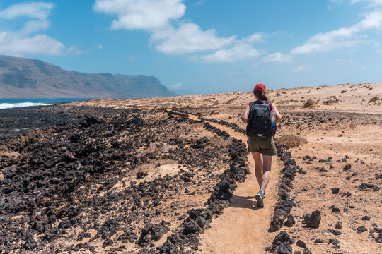 Girl hiking on La Graciosa Island, sustainable travel escape destination healty lifestile Canary Islands Spain