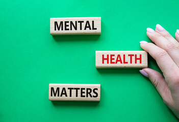 Mental Health Matters symbol. Concept words Mental Health Matters on wooden blocks. Beautiful green...