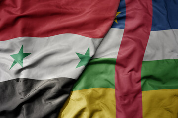 big waving national colorful flag of central african republic and national flag of syria .