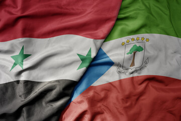 big waving national colorful flag of equatorial guinea and national flag of syria .