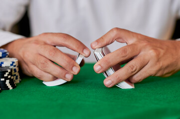 Closeup of hands shuffling cards in casino