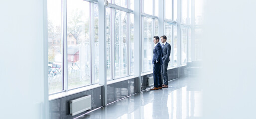 Full length portrait of Business team stand near the window in conference room. - 755893929