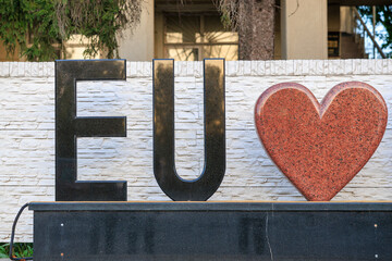 Text EU and heart, concept of love for the European Union. Background with selective focus and copy space