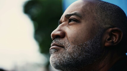 One meditative pensive middle-aged black hispanic man closing eyes in contemplation. Close-up of a...