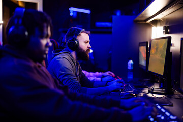 Young bearded male gamer on a cybersport tournament in a Esports arena