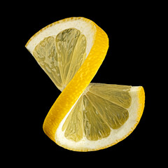 Twisted lemon slice on black background, full depth of field - 755912532