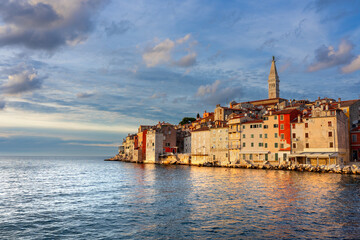 warm sunlight hit the city of Rovinj with the adriatic sea and rocks
