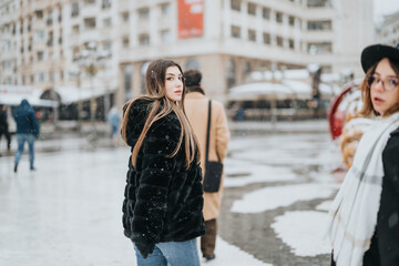 Bright-minded business colleagues traverse a snowy urban landscape, capturing the essence of winter while networking outdoors. - obrazy, fototapety, plakaty