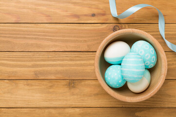 Blue easter eggs on wooden background, top view