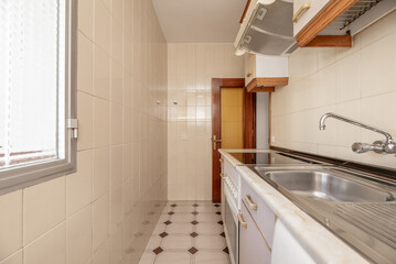 A small kitchen furnished with furniture on a single wall