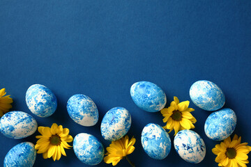 Blue and white Easter eggs with yellow flowers. Happy Easter card