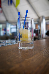 there is a piece of pear in a shot glass