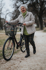 Mature woman holding her bicycle, preparing for a ride along a serene park path, depicting an...