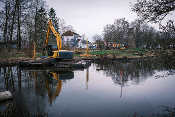 A lake is dredged with a floating dredger
