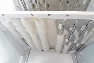 Fototapeta na wymiar Ice in the freezer, Defrosting of the fridge and freezer