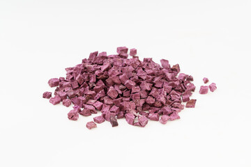 Multiple dried purple sweet potatoes on white background